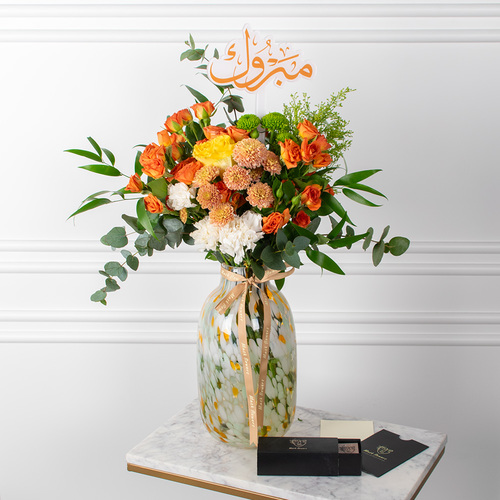 Tiger Bouquet - A vase filled with chrysanthemums, roses, carnations and eucalyptus along with chocolates.