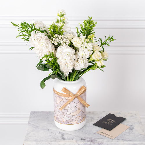 Lovely White - Roses and hydrangeas arranged beautifully in a vase with a card.