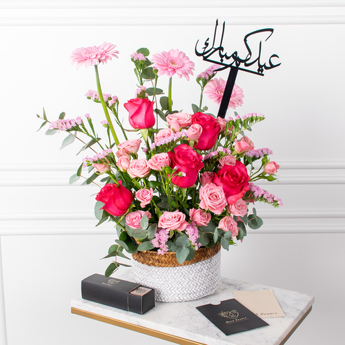 Ghandy - A basket that contains roses, gerbera and chocolate box.