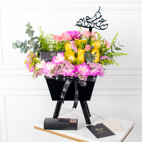 Blossom Basket - An elegant basket featuring roses, baby roses, gerbera, carnations, and gypsophila. Comes with an acrylic sign