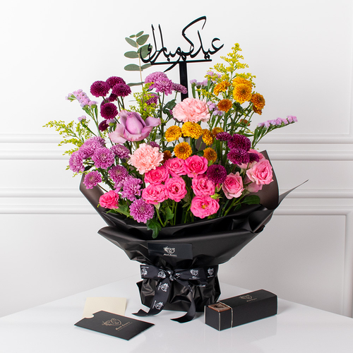 Sandy 1 - A hand bouquet of roses, carnations, and chrysanthemums arranged beautifully with a card, chocolates, and an acrylic topper.