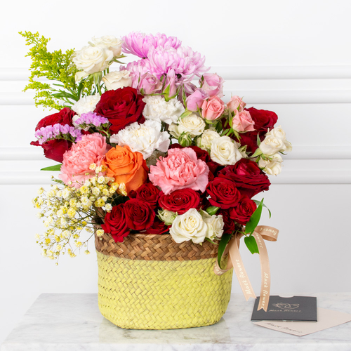 Romantic Flowers - Roses, baby roses, carnations, and chrysanthemums arranged beautifully in a basket with a card.