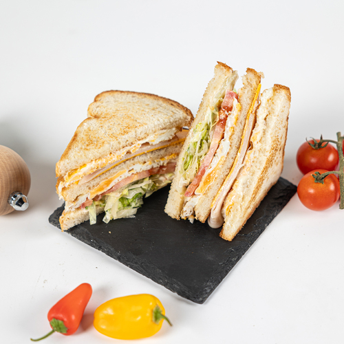 Club Sandwich - Double stacked on griddles toast, fried eggs, smoked turkey, Lettuce, Tomato & Cheddar cheese.