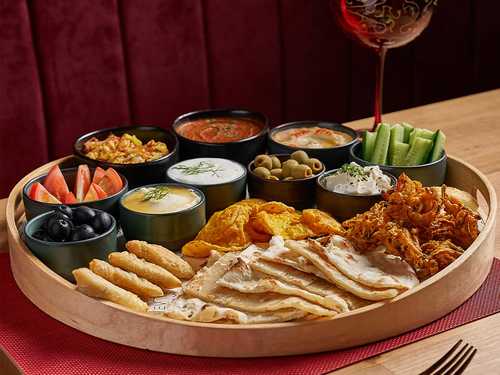 Indian Breakfast Platter - Aalo Bhaji, Poori, Akuri, Chapati, Assorted Pakoda, Cheese Samosa, Rasgulla.