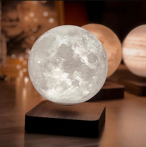 Khaled Dark Base Levitating Moon - Moon with three shades of light (white/yellow/orange) levitating and spinning over a dark brown wooden colored base. Comes with a button to choose between the three shades of light. Could be left spinning on day and night with lights ON/OFF Moon : D: 14cm distance : 12-15 mm Base : 13.4cm*13.4cm*33mm