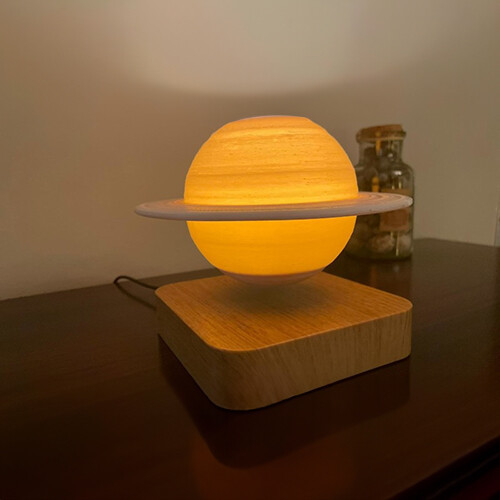 Light Base Levitating Saturn - Saturn with three shades of light (white/yellow/orange) levitating and spinning over a light brown wooden colored base. Comes with a button to choose between the three shades of light. Could be left spinning on day and night with lights ON/OFF Moon : D: 14cm distance : 12-15 mm Base : 13.4cm*13.4cm*33mm