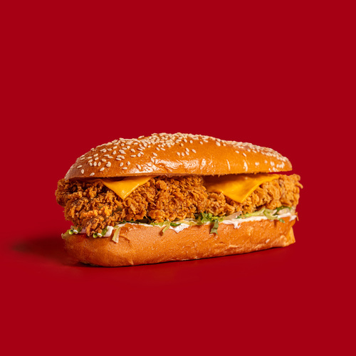 Super Fillet - Experience a flavorful feast with our Super Fillet sandwich. A crispy chicken breast, creamy mayo or fiery hot sauce, and fresh lettuce are layered between a long, French potato bun with sesame seeds, topped with melted cheese for a delicious and filling bite.