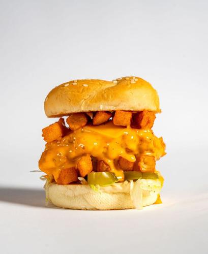 Mini Zinger - Ignite your taste buds with our Mini Zinger. A crunchy sesame bread covered juicy chicken breasts topped with spicy dynamite sauce, layered with fresh lettuce, melted cheese, jalapeno pieces and topped with a layer of spicy peri-peri fries.
