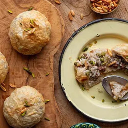 Levantine Ouzie Bundles Gathering - Dough bundles stuffed with rice, peas ,meat and nuts served with cucumber yogurt salad.