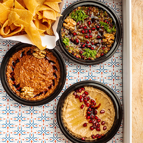 Trio Box Dips - Muhammara,Mutabal and Baba Ghanough served in a gathering box with crispy bread.