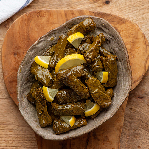 Yalanji - Grape leaves stuffed with rice, tomatoes and parsley simmered in lemon water and olive oil.