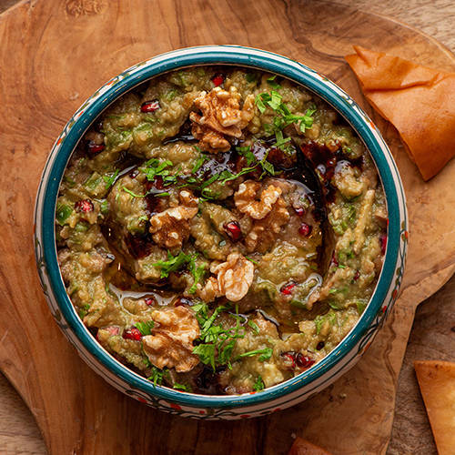 Baba Ghanoush - Smoked eggplant mixed with green bell pepper, walnuts, pomegranate molasses and served with your choice of bread.