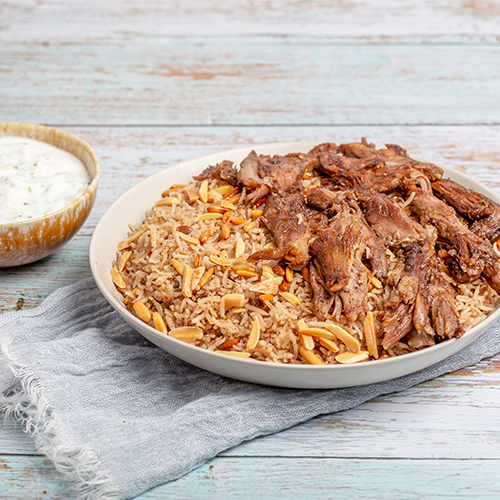 Oriental Mix Rice With Meat - Rice mixed with minced beef, spices, topped with nuts, served with meat and cucumber yogurt salad