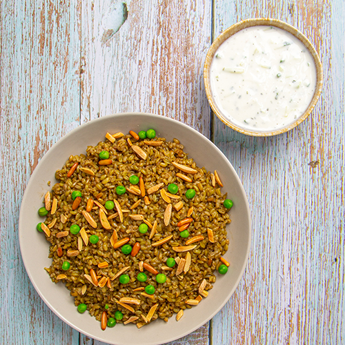 Freekeh - Freekeh topped with nuts and served with cucumber yogurt salad.