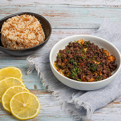 Minazalat Alzahra - Fried cauliflower topped with coriander, garlic and minced beef served with vermicelli rice .