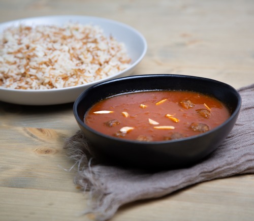 Kibbeh Hamees - Bulgur Kibbeh cooked in tomato sauce served with vermicelli rice.