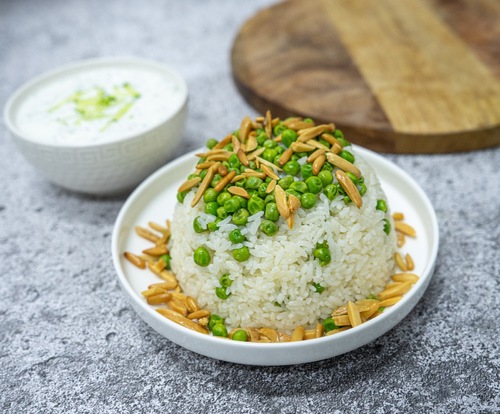 Rice with peas - Rice cooked with peas garnished with nuts served with cucumber yogurt salad