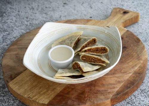 Lahm Ajeen - Bread stuffed with spiced minced meat served with tahini