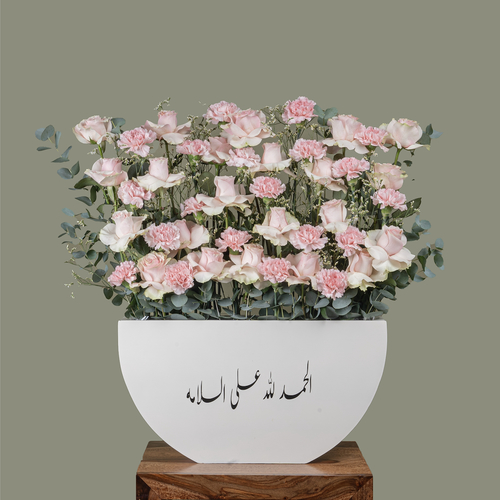 Pastel Pink - A box filled with roses and green leaves.