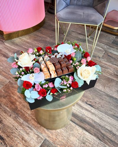 B Levels - A medium sized box contains a mix of roses and 250 grams of swiss chocolate