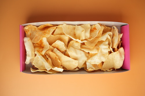 Papad box with dips - indian crisps with green chutney and tamarind sauce