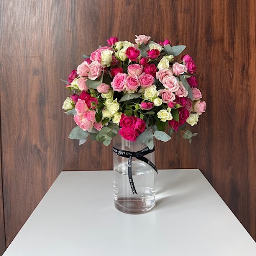 Bouquet Recipe - A glass vase that contains variety colours of baby roses and eucalyptus.  Height: 49cm – Width: 39cm