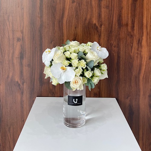 You Matter - A glass vase that contains baby roses, roses, orchid petals, and eucalyptus.   Height: 48cm – Width: 38cm