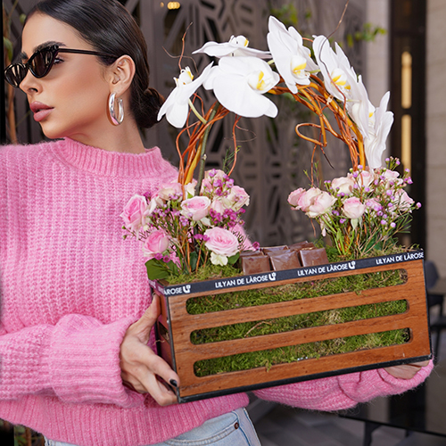 Fifty's Century - This wooden basket contains orchid petals, baby roses, and wax flower with Belgian chocolates. Height: 43 cm - Width: 41 cm