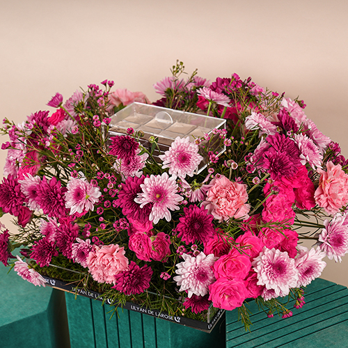 Leah - An acrylic tray that contains mixed of chrysanthemum flowers, baby roses and wax flowers with Belgian chocolates.Height: 30 cm - Width: 55 cm