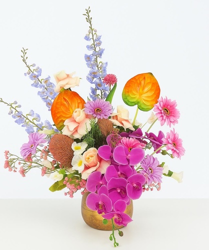 Infinity Blossom (Artificial) - A timeless statement piece designed to bring elegance that never fades. This high-quality artificial arrangement combines vibrant orchids, soft roses, and tropical accents in a stunning ceramic vase. Handcrafted with precision, it is perfect for adding everlasting beauty to homes, offices, or special spaces.