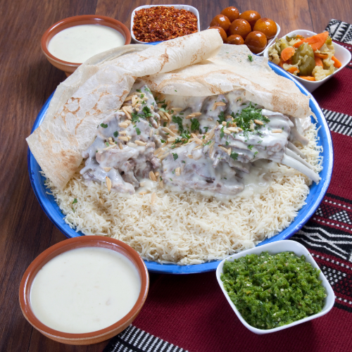 صينية منسف لحم - ارز بسمتي مع لحم مطبوخ مع جميد, مكسرات وحشو يقدم مع مرق المنسف, معبوج احمر, معبوج اخضر, اجار ولقيمات