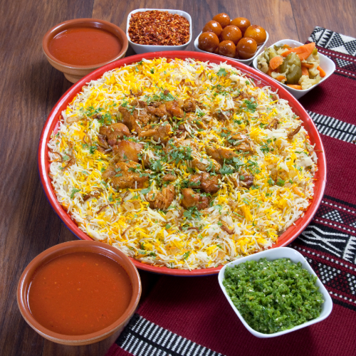 Chicken Biryani Tray - Basmati rice with chicken and spices served with broth, red mabog, green mabog and Luqaimat