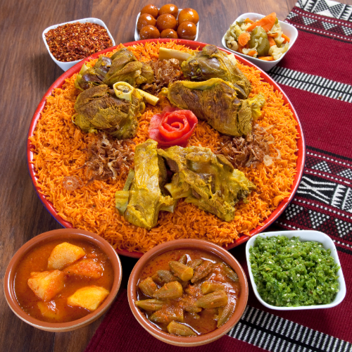 Kabsa Tray With Fresh Arabic Meat - Basmati Rice With Tomato Sauce, Spices, And Fresh ARabic Meat Chops With Hasho Served With Broth, Red Mabog, Green Mabog And Luqaimat