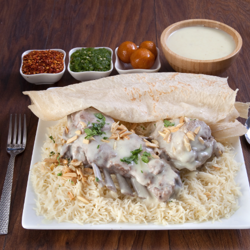 Arabic Meat Mansaf - Basmati rice with arabian meat prepared with jamid, nuts and hasho served with mansaf broth, red mabog, green mabog, agar and luqaimat.