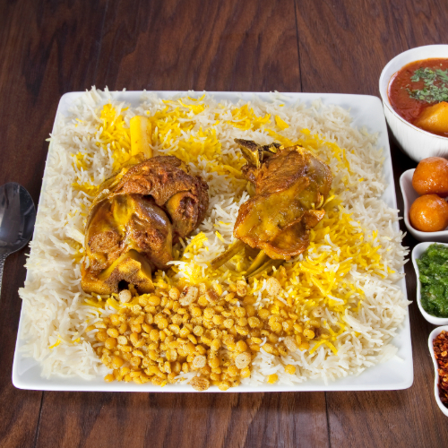 Arabic Meat Majboos - Meat cooked in tomato sauce with spices, spices served with white bread, red maabouj, green maabouj, and agarolguimat.