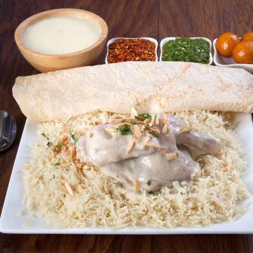 Mansaf Chicken - Basmati rice with  chicken prepared with jamid, nuts filling served with mansaf broth, red maabouj, green maabouj, agar and luqaimat