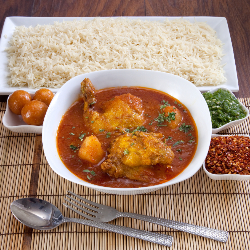 Marag Chicken - chicken prepared with tomato sauce, spices served with white rice, red maabouj, green maabouj, agar and luqaimat