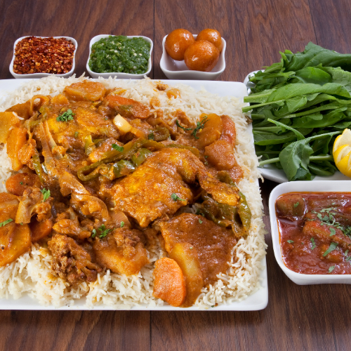 Maklouba Chicken - Basmati rice with  chicken, vegetables prepared with spices served with broth, red maabouj, green maabouj and luqaimat