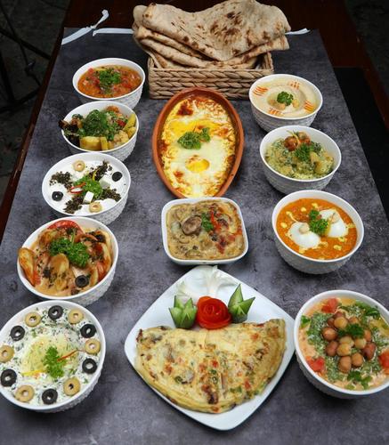 BREAK FAST BOX OTHMAANY - turkyesh egg EGG CURRY Humous foul mussabah (humous w/ humous whole ) mix veg HAMSA HALLOUM W/ TOMATO HAMSA POTATO W/CAULIFLOWER HAMSA MUSHROOM W/ CREAM Egg omelet Labnah W/ Zatter MIX CHEESE SAUCE W/ HALLOUM &OLIVES Bread