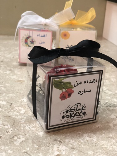 Eid giveaway - mini box minimum order 12 boxes size : 8cm black ribbon red cream Please keep your writing that you want on the Sticker in the box below