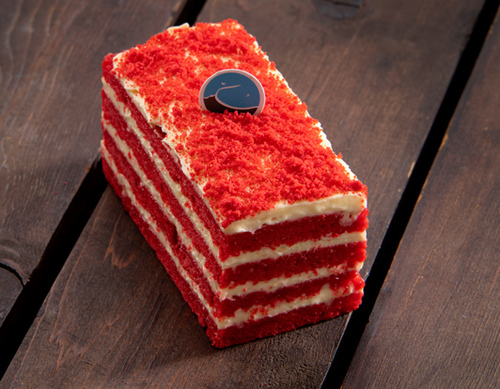 Red velvet cake slice - Consists of Red velvet sponge, buttermilk, and cream cheese