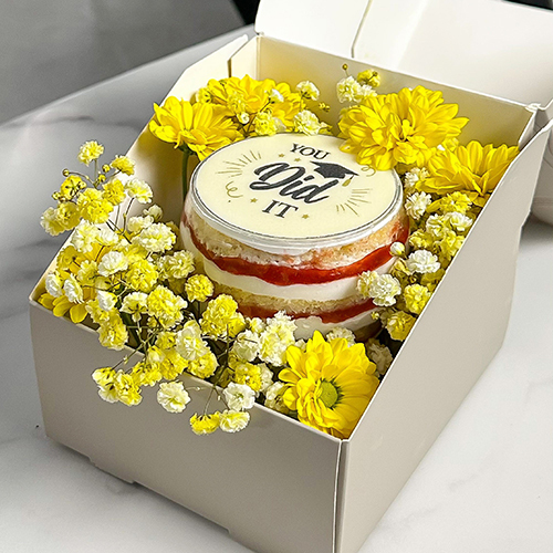Gerbera Blossom High Ball Cake - A stunning dessert presented in a high ball glass, surrounded by fresh gerbera daisy flowers for a naturally elegant touch. Inside, layers of soft vanilla cake are paired with airy chantilly cream and a vibrant wild berry compote bursting with flavor. A floral-inspired delight as beautiful as it Is delicious Enough for share with 2 personSize :Height 7cm Width 9.5 cm
