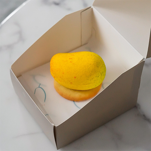 Alphonso Mango Crush - Mango shaped cake with layers of vanilla and mango cream, Alphonso mango filling, topped with white chocolate and a light crunch.