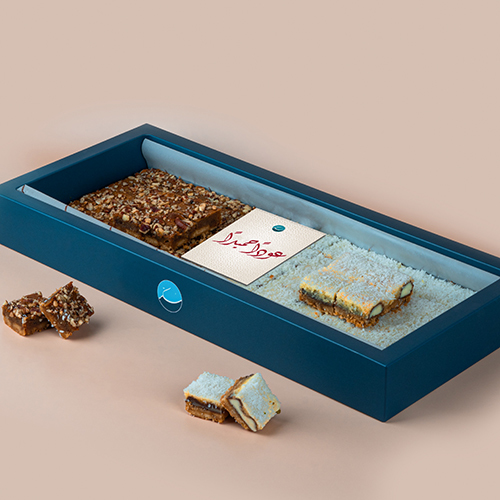 SCHOOL PECAN DELIGHT KINDER BITES - A box of our special products consisting of   2 flavors mixed with oriental cheese and biscuits, pecan , dates, and kinder with coconut
68 piece   ,  With Choco print on top