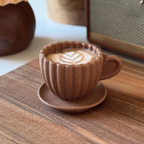 Chocolate Latte - Chocolate Latte A milk chocolate cup filled with silky chocolate cream and layers of soft cake and biscuit, offering a rich and delightful flavor.