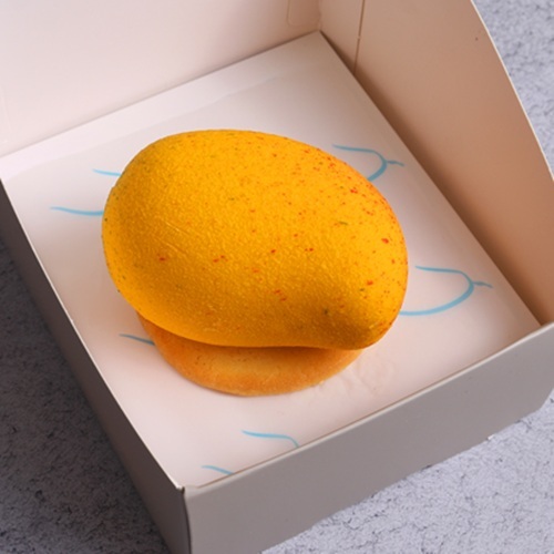 Alphonso Mango Crush - Mango shaped cake with layers of vanilla and mango cream, Alphonso mango filling, topped with white chocolate and a light crunch.