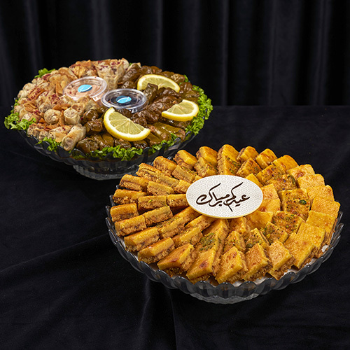 Mix Sukkar + Mawajib Salty Bowl - Mix Sukkar Bowl – 63 Pieces&nbsp;🌙🍫 A delightful assortment featuring&nbsp;three mixed flavors&nbsp;combined with:Oriental cheese and biscuits Pistachio nuts Dates Salted caramelPerfect for&nbsp;Eid gifting, family sharing, and festive treats. +Mawajib Salty – Mosakan & Vine Leaves** 🌙🥟  **Mosakan – 40 Pieces** A savory assortment of traditional **Mosakan pastries**, perfect for Ramadan iftar and family gatherings.  **Vine Leaves – 40 Pieces** Delicious **stuffed vine leaves**, filled with flavorful rice and herbs, ideal for festive Eid&nbsp; meals.  Perfect for **sharing with family and enjoying traditional Eid&nbsp; flavors**.