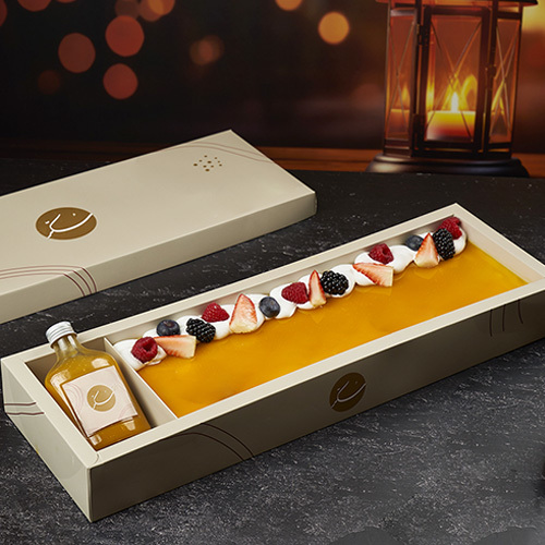 Mango Cake - Soft vanilla cake layered with rich Alphonso mango cream, finished with smooth chantilly cream and topped with fresh berries for a perfectly balanced fruity touch.