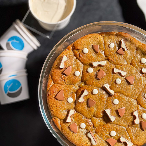 Hot Kinder Cookies - Warm chocolate chip cookie filled with creamy Kinder, topped with chocolate Served with vanilla gelato