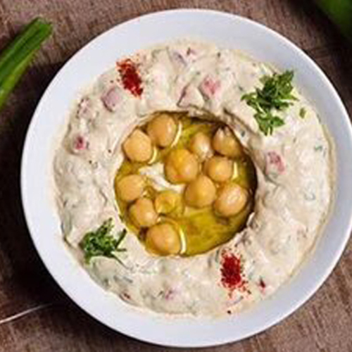 Hummus Beiruti - The Famous Hummus Beiruti with Vegetables, Tomatoes, Onions, Parsley, and Mint With Flavoring.